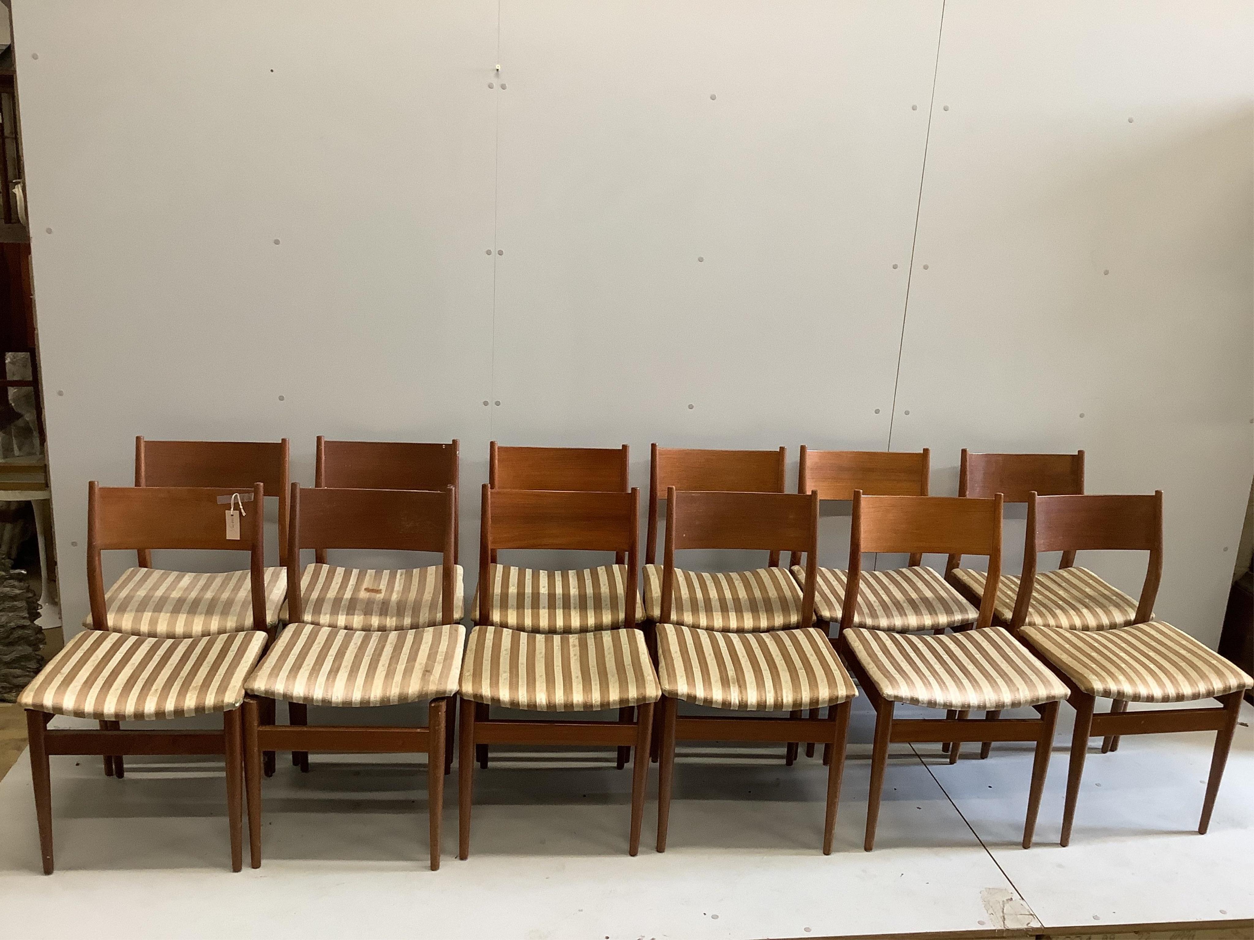 A mid century Gordon Russell teak dining suite comprising rectangular extending table, twelve chairs and a sideboard, width 140cm, depth 80cm, height 74cm. Condition - fair, with the leaf in it's an eight seater